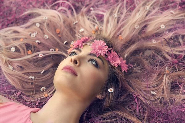 A girl with a wreath and flowers in her hair