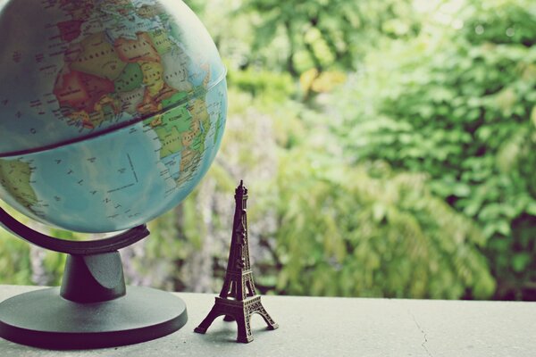 Globe and statuette Eiffel Towers nearby