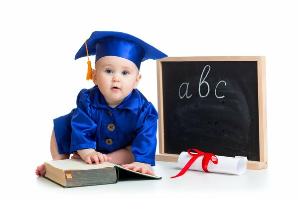 A baby in a blue robe with a book