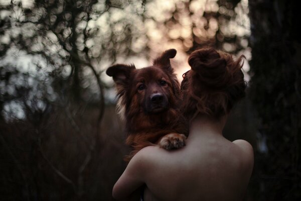 A girl with a dog in the forest