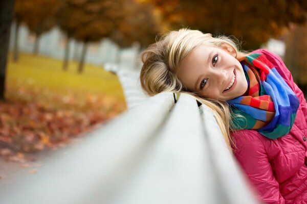 Funny girl on a park bench