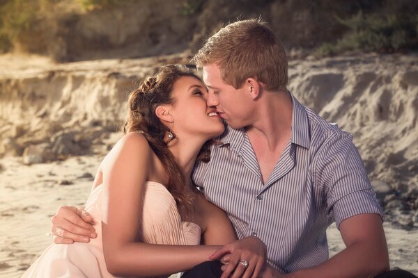 Couples in love sitting on the lake kissing each other