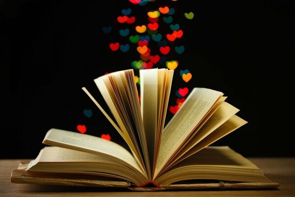 An open book with hearts