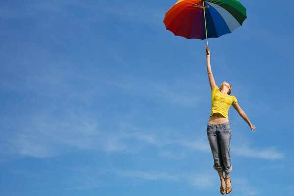 Girl with an umbrella bright flight into the sky