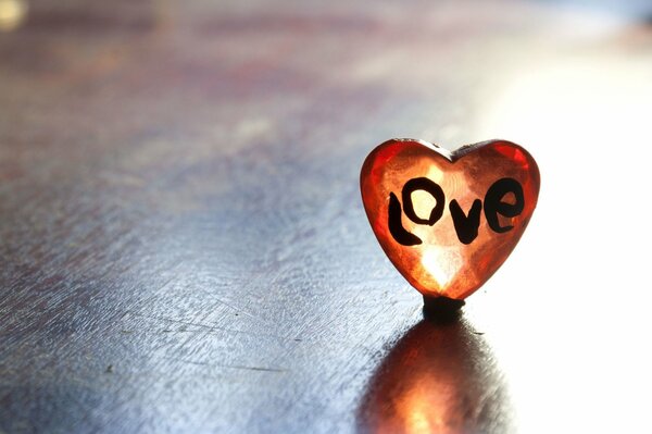 A heart with the inscription love on a wooden table