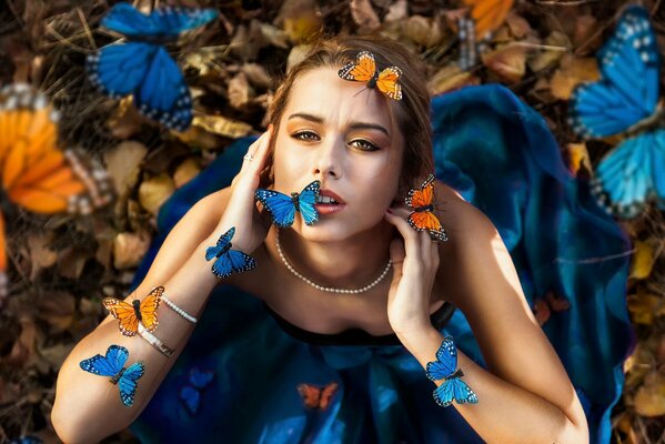 A girl in butterflies in a satin dress