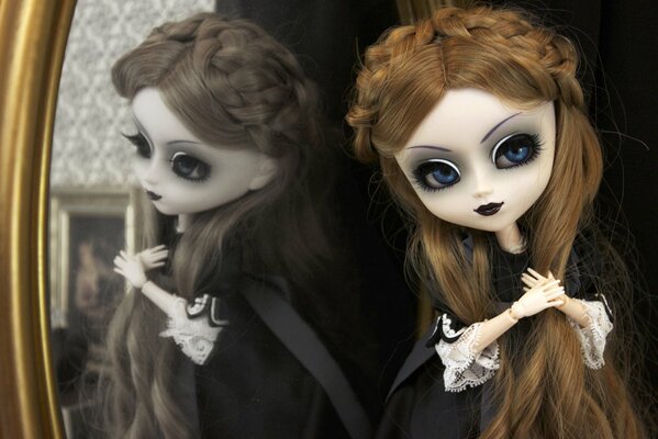 Gothic doll at the mirror in a black dress