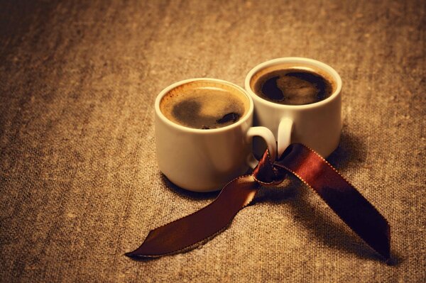 Two linked coffee mugs