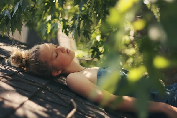 A beautiful girl is sleeping. The girl is resting. Sleeping in the fresh air