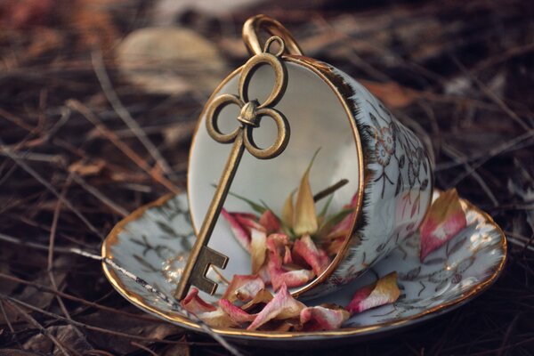 A golden key on a cup and saucer