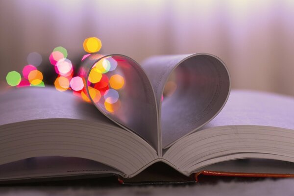 The pages of the book are folded with a heart