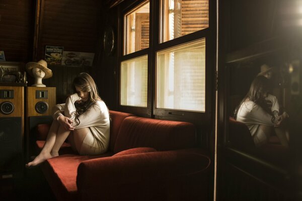 Lonely girl sitting on the couch