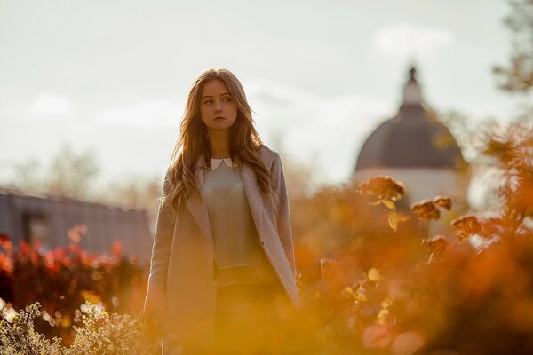 Autumn. girl on the background of the temple