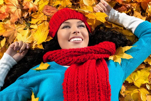 Beautiful brunette in autumn leaves