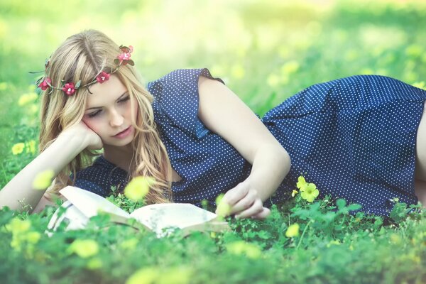 Keri Ruth Garcia is lying down and reading a book