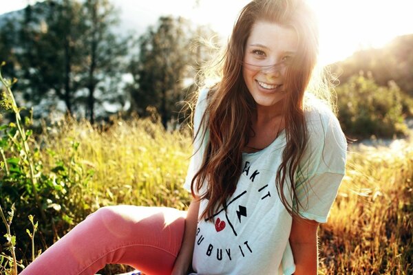 A girl in pink trousers at the summer edge