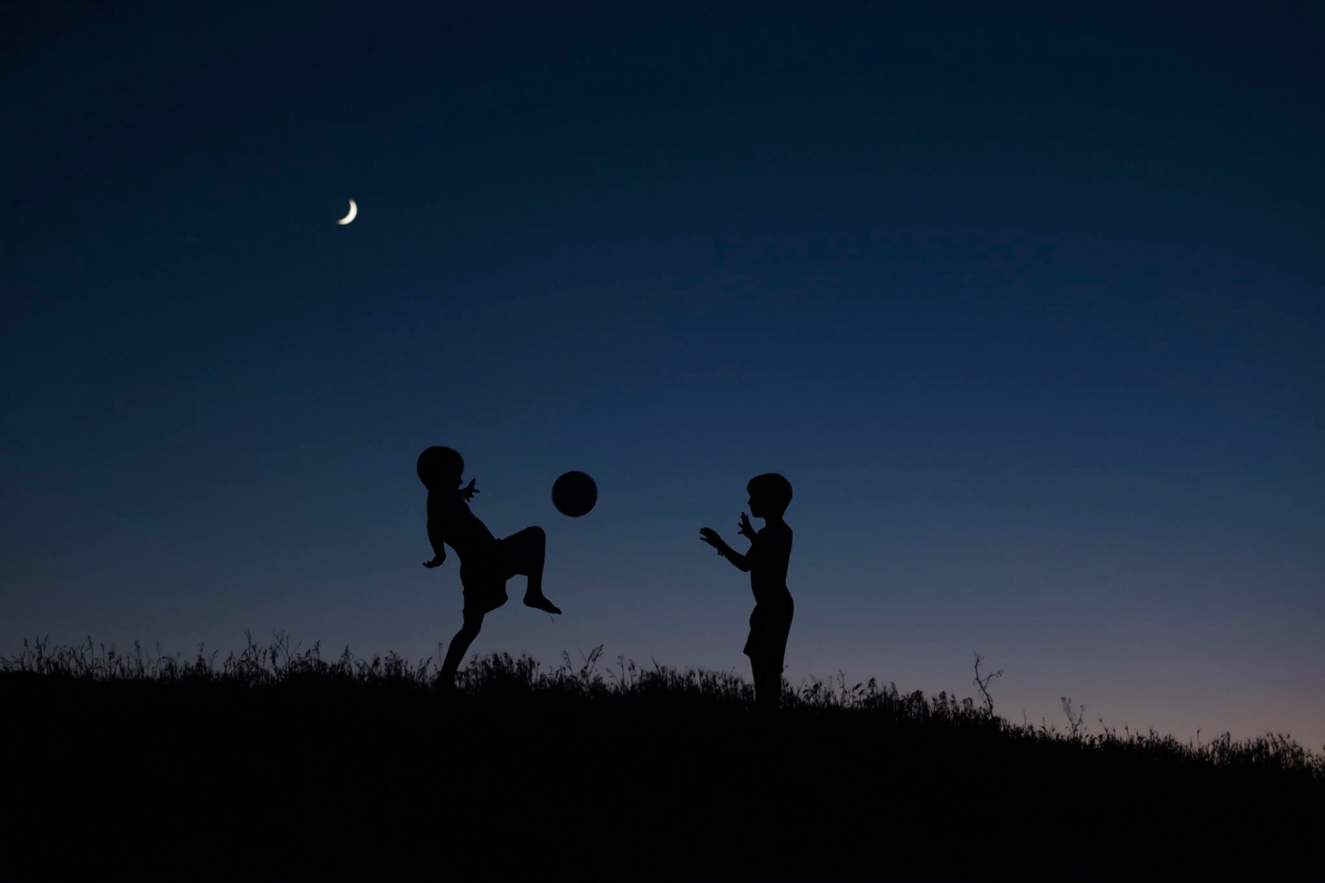 children silhouettes night ball game