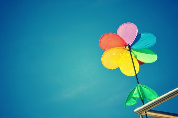 A bright pinwheel on a blue sky background