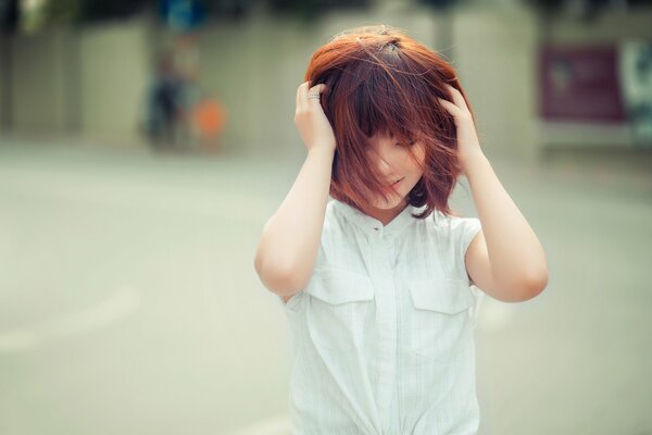 The oriental red-haired girl has a happy smile