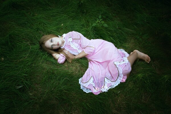 A girl in a delicate pink dress