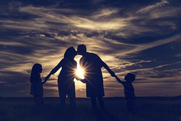 Family at the sea meets the sunset