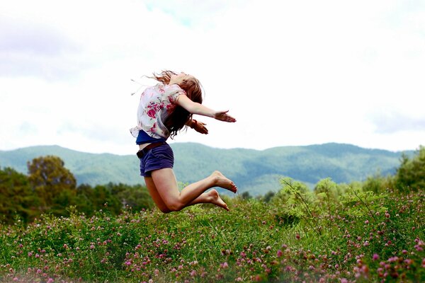 The girl jumps conveying the mood of lightness and freedom