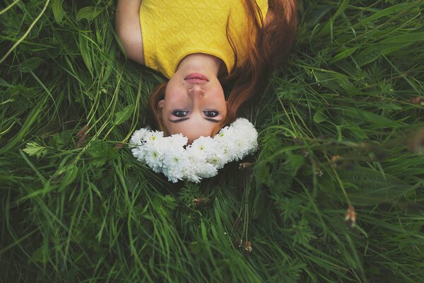 In a wonderful picture, a red-haired girl with a wreath