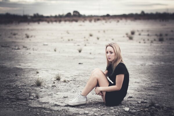 A lonely girl in the middle of a deserted street