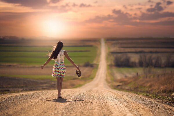 Barefoot girl walking down the road