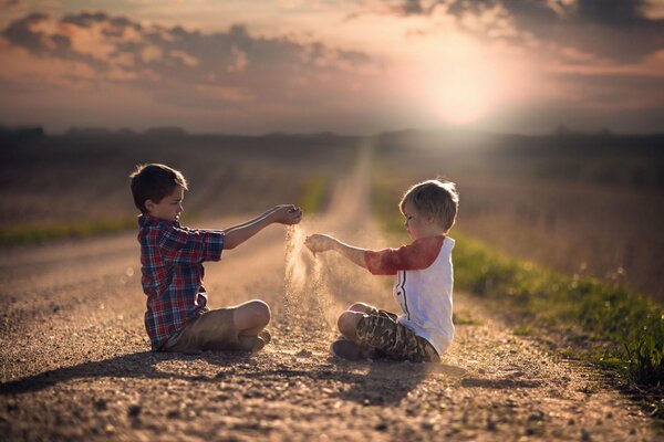 Children are pouring sand on the road