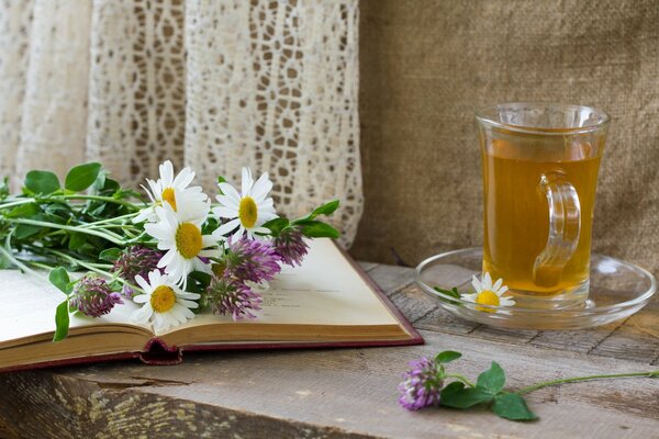 Summer reading of a book with a glass of tea