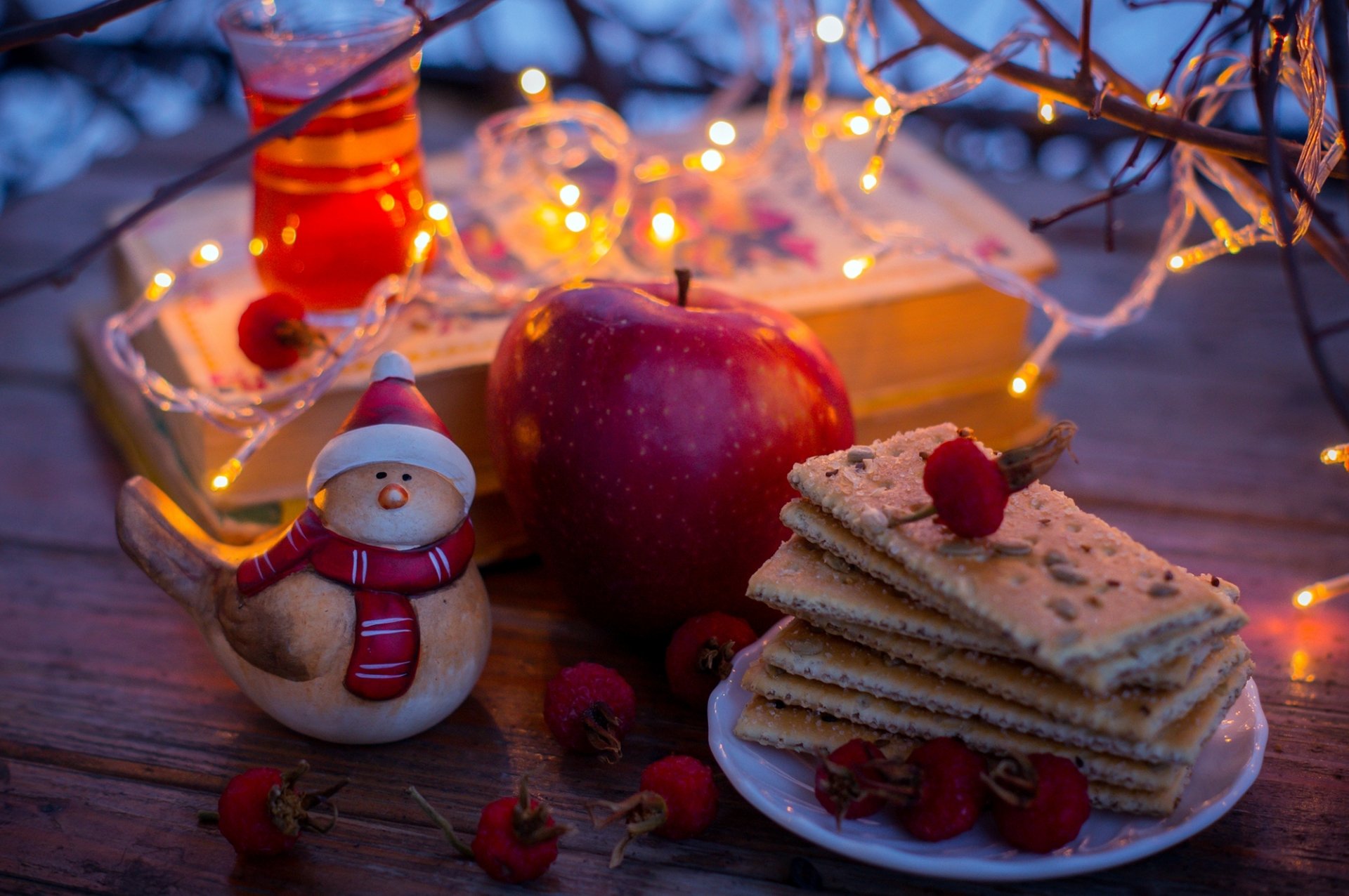 cookies tea berries red apple books statue garland lights yellow