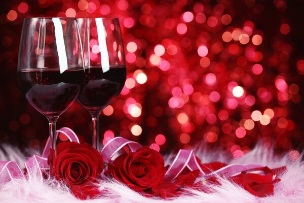 Glasses of red wine and red roses as a gift with a cup of tea an unedited letter