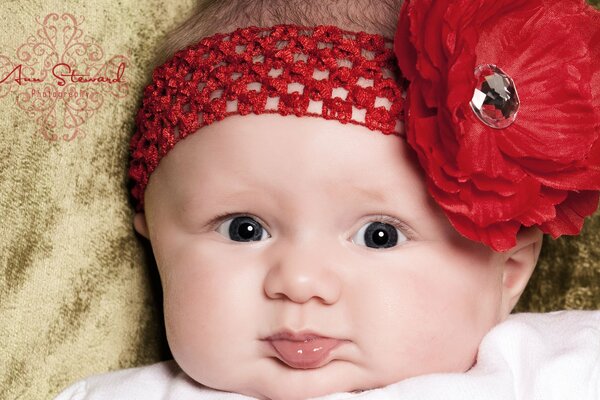 A little girl in a bandage with a red bow