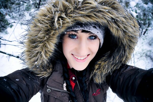 Selfie of a smiling girl in a hood