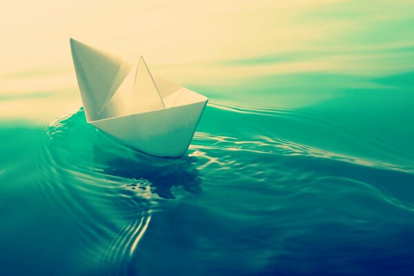 Paper ship boat floats on the water