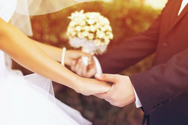 Wedding bouquet in the hands of the bride