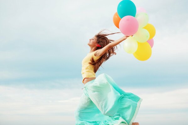 Happy girl with balloons in her hands