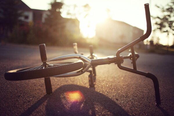 Fahrrad auf Asphalt, von der Sonne beleuchtet