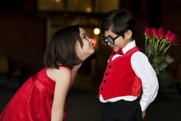 A boy with a bouquet of red roses