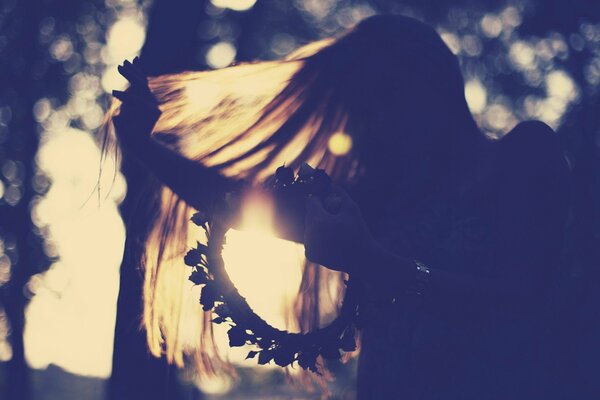 Sunny mood of a girl in a pink wreath