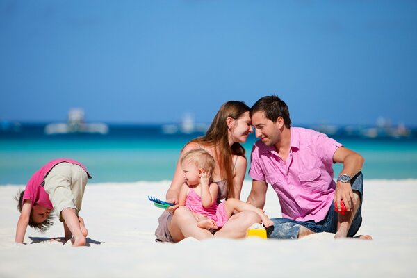 Happy family with children on the beach