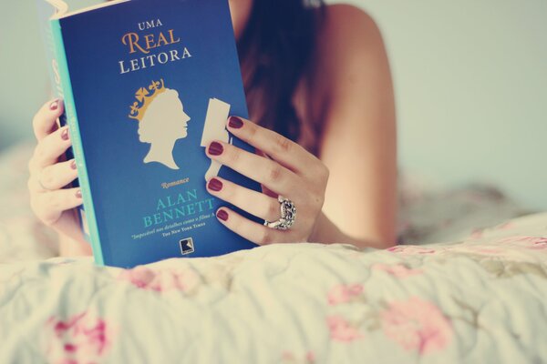 A girl reads a blue book