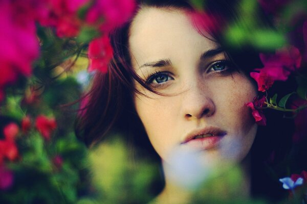 Girl with light makeup in flowers