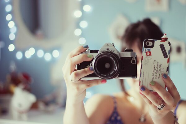 Selfie photo of a girl with a camera