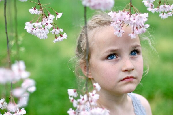 Niña triste en un Jardín floreciente