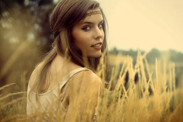 A girl with brown hair in a field