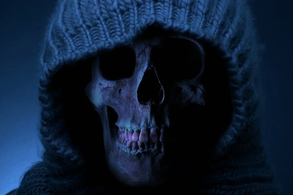 A hooded skull with lilac teeth