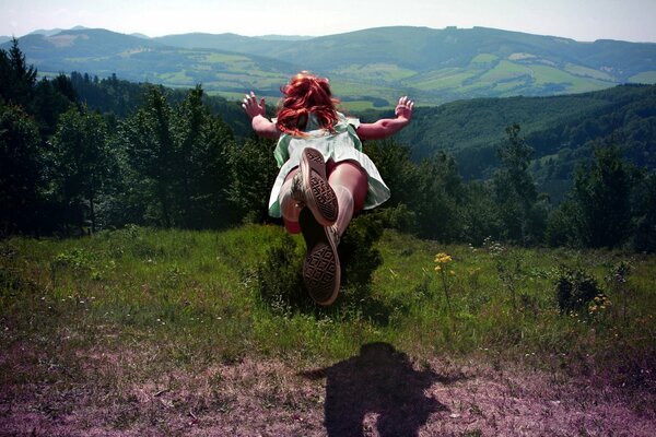 A girl surrounded by hills, forests, mountains