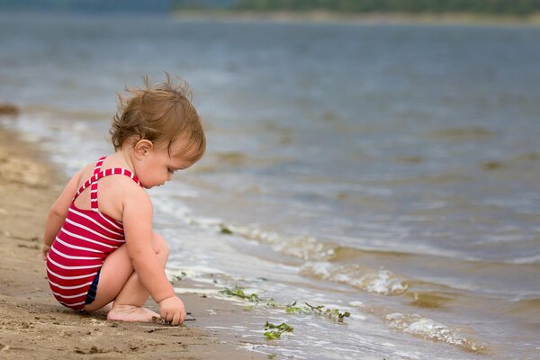 A child by the water. Gentle sea